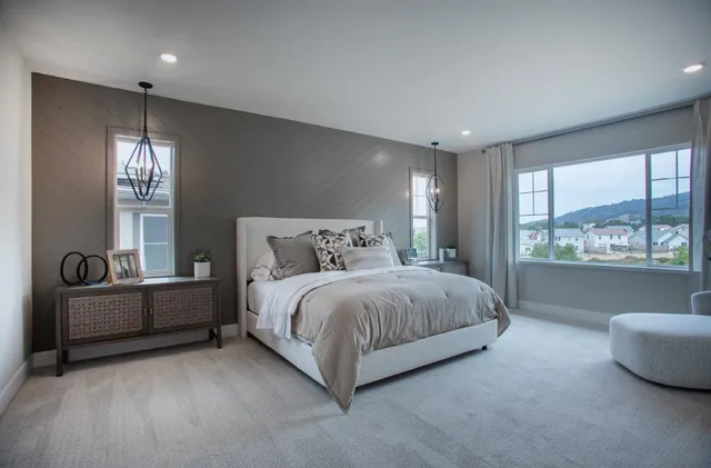 a spacious bedroom with a bed and large window