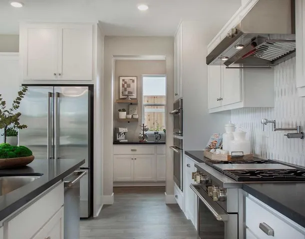 a kitchen with stainless steel appliances and wooden cabinets