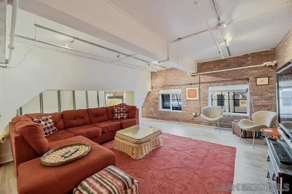 950 Sixth Avenue, Unit 211 San Diego, CA 92101 - Photo 4 of 8 a living room with furniture ceiling fan and a rug
