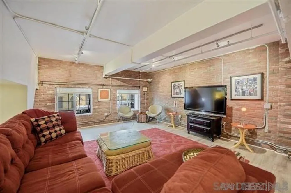 950 Sixth Avenue, Unit 211 San Diego, CA 92101 - Photo 6 of 8 a living room with furniture and a flat screen tv