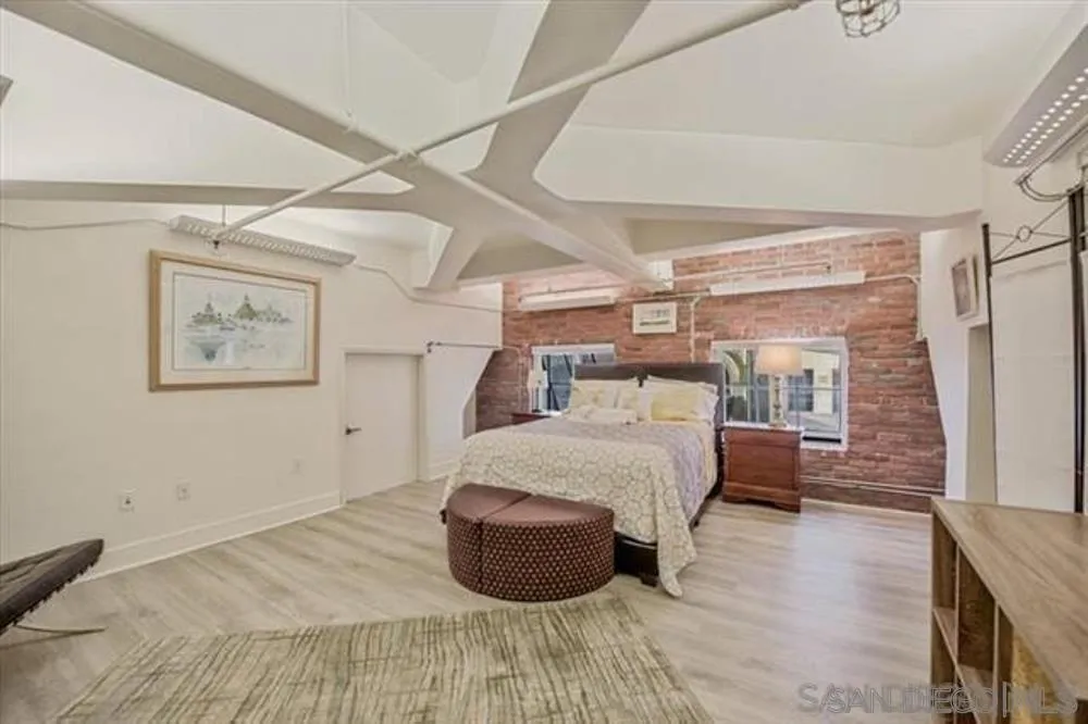 950 Sixth Avenue, Unit 211 San Diego, CA 92101 - Photo 7 of 8 a bedroom with a bed and wooden floor