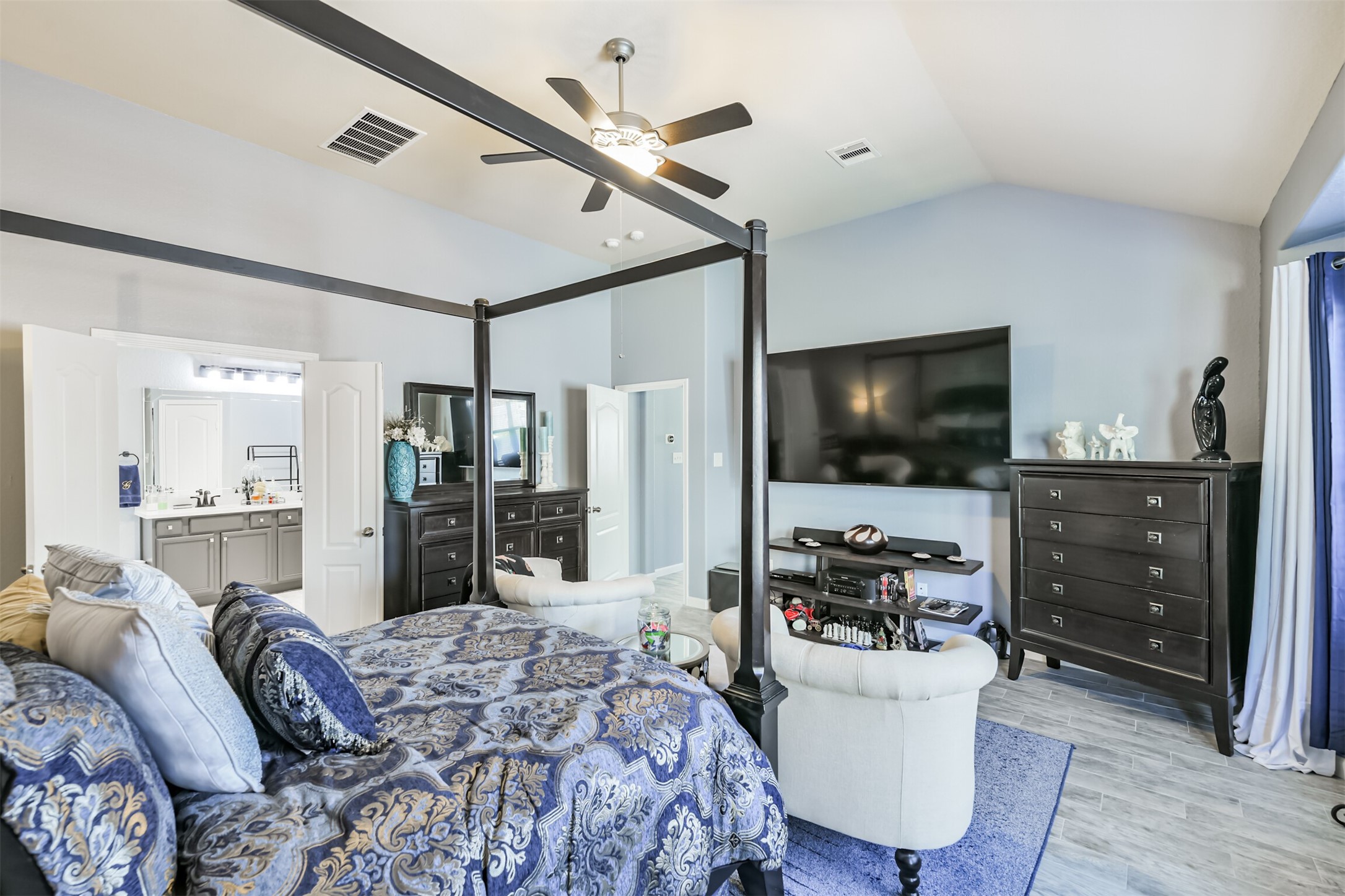 24047 Schults Meadow Lane Spring, TX 77389 - Photo 24 of 47 a bedroom with furniture and a flat screen tv