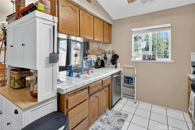 a kitchen with granite countertop a stove and a sink