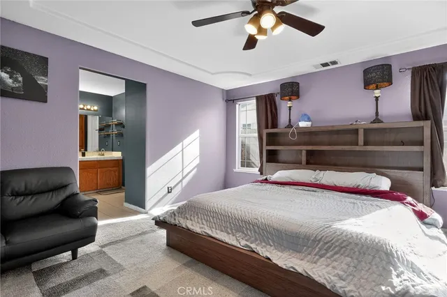 a bedroom with furniture and a chandelier