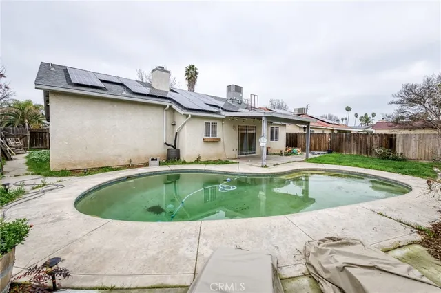 a view of a backyard with wooden fence