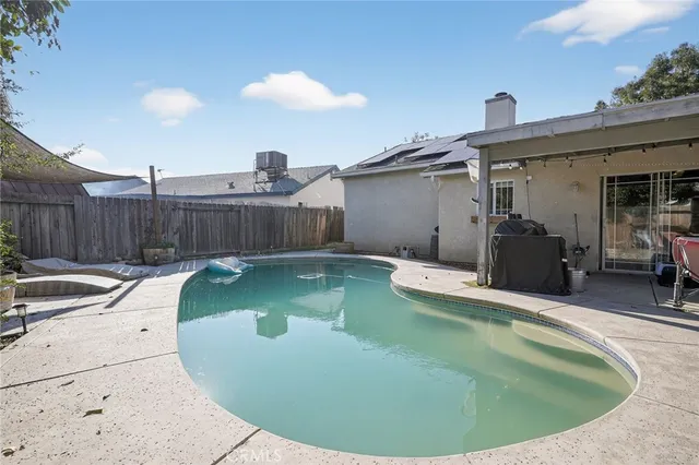 a view of a swimming pool with a patio
