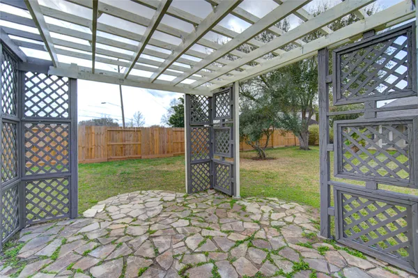 a view of a backyard with a large tree