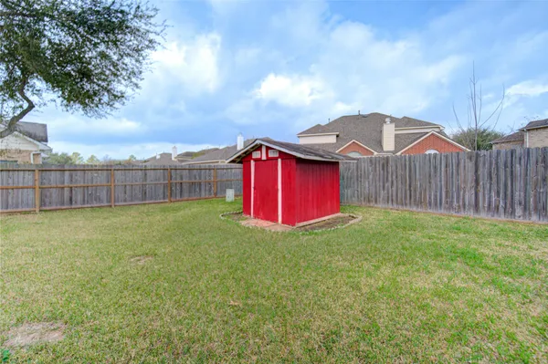 a yellow and red umbrella sitting in front of a house