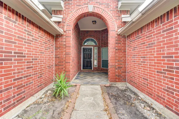 a view of a brick house with potted plants