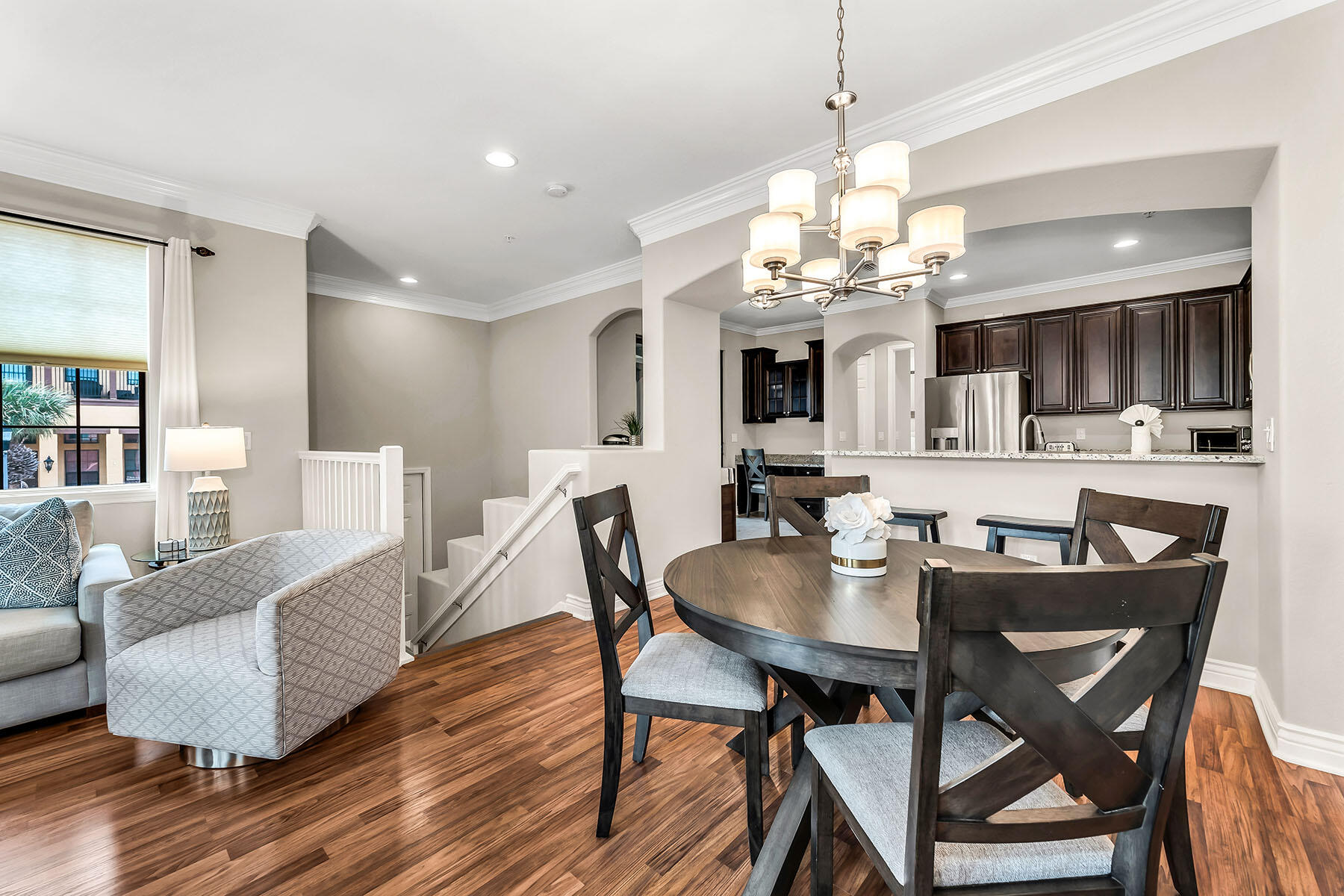 9066 Albion Lane North, Unit 5101 Naples, FL 34113 - Photo 15 of 48 a view of a dining room with furniture wooden floor and chandelier