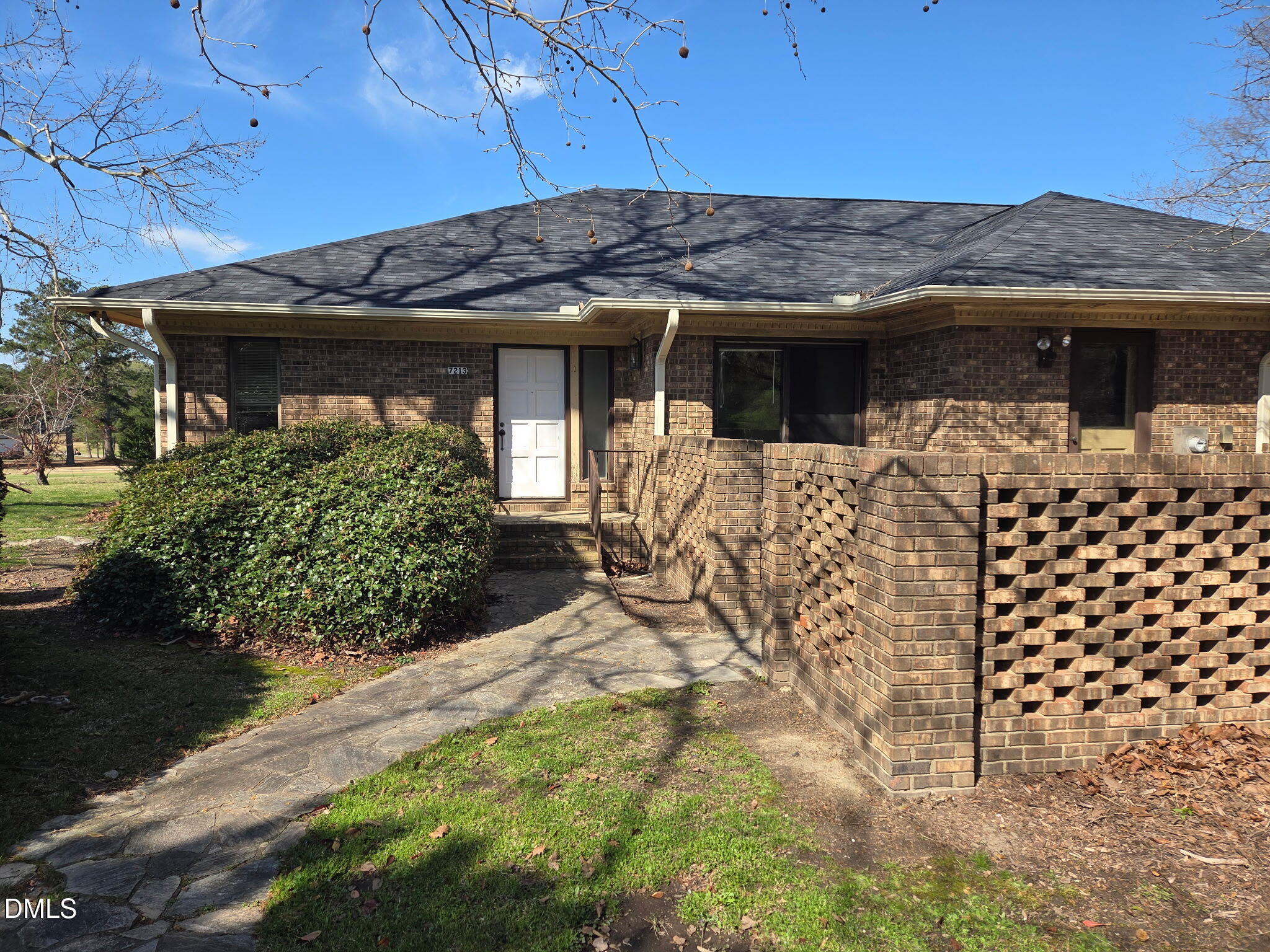 a view of a house with wooden fence