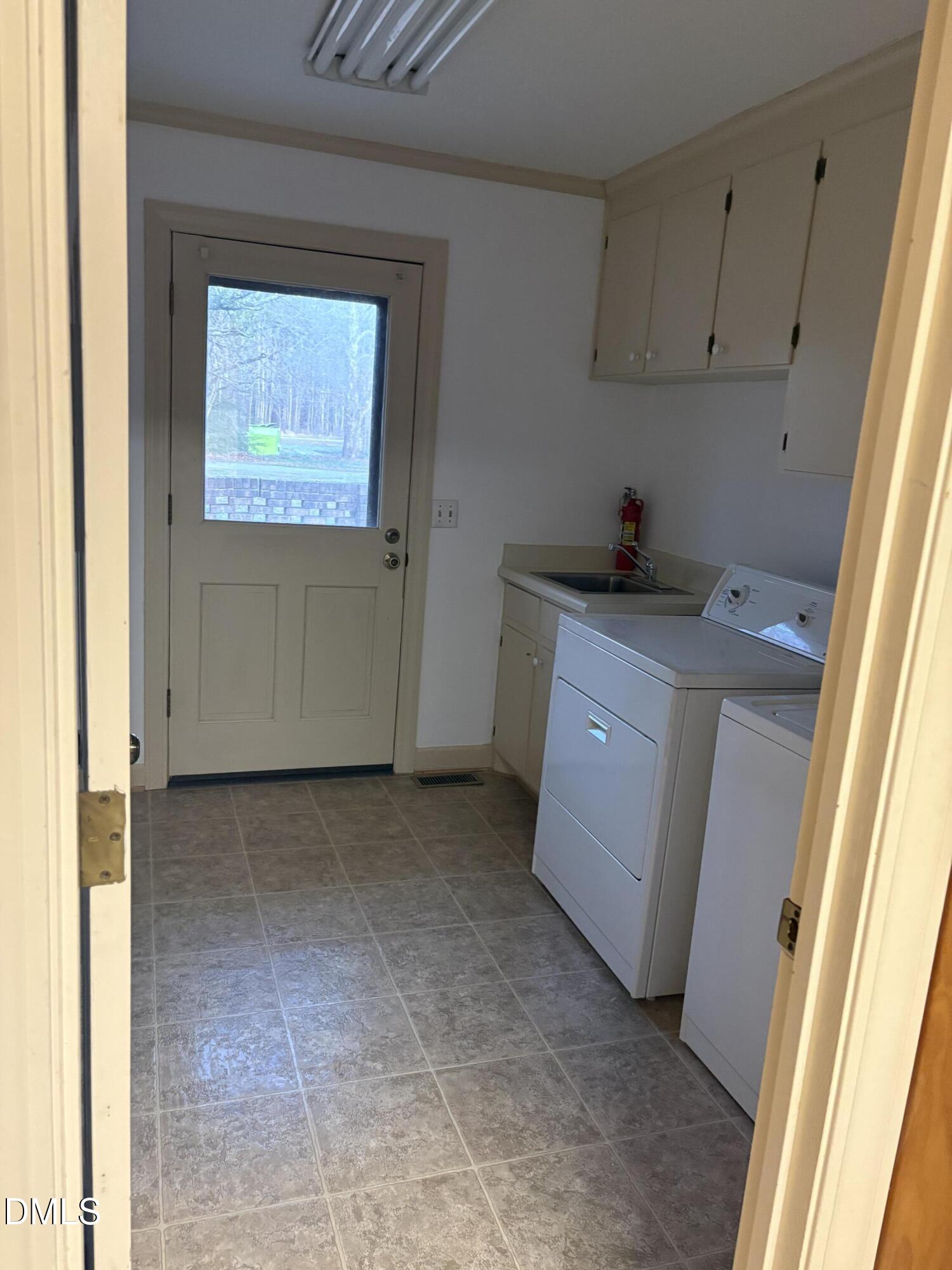 7213 Ridgefield Court Sanford, NC 27332 - Photo 12 of 17 a utility room with a sink a washer and dryer