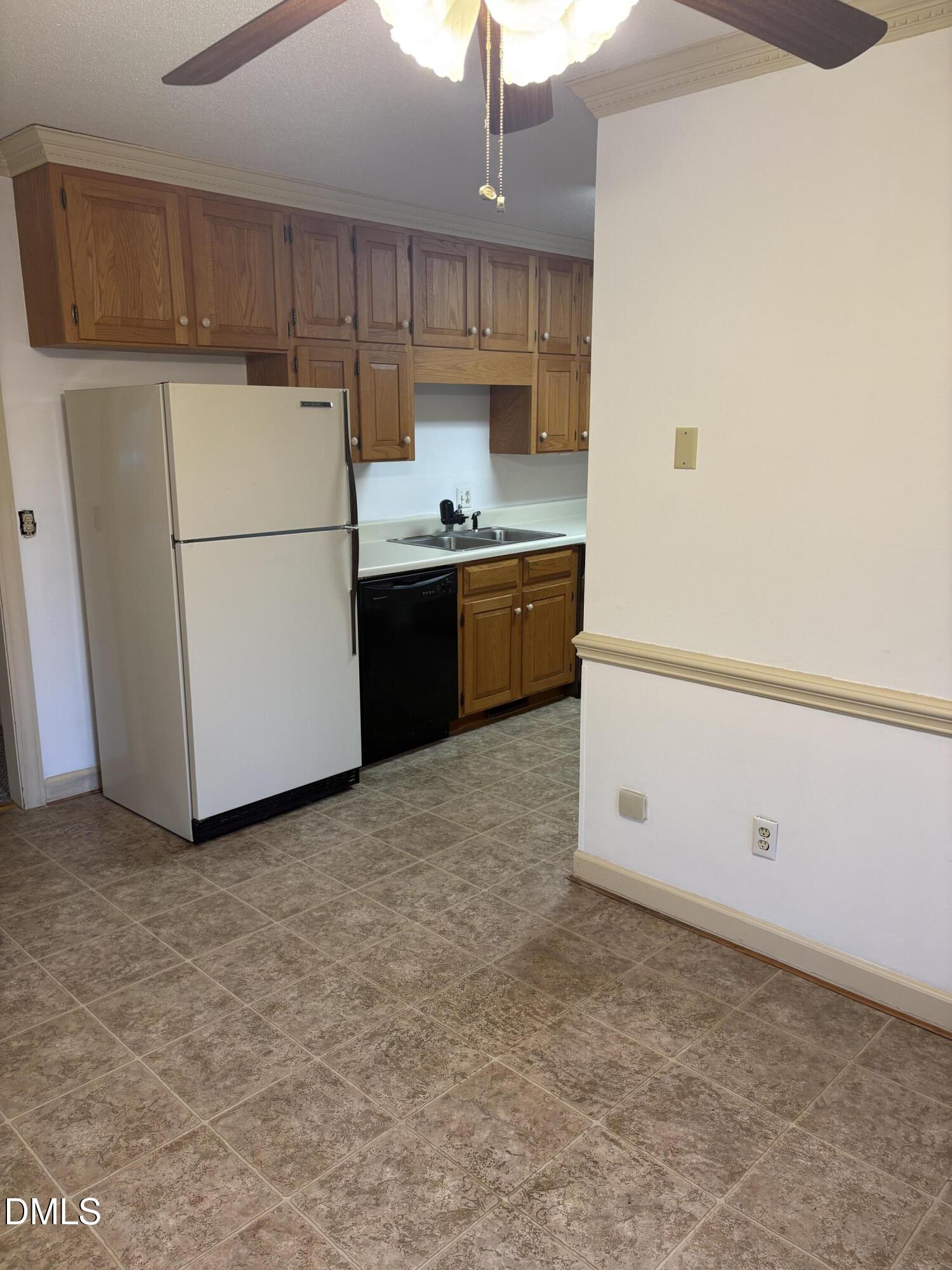 7213 Ridgefield Court Sanford, NC 27332 - Photo 5 of 17 a kitchen with a refrigerator sink stove and cabinets