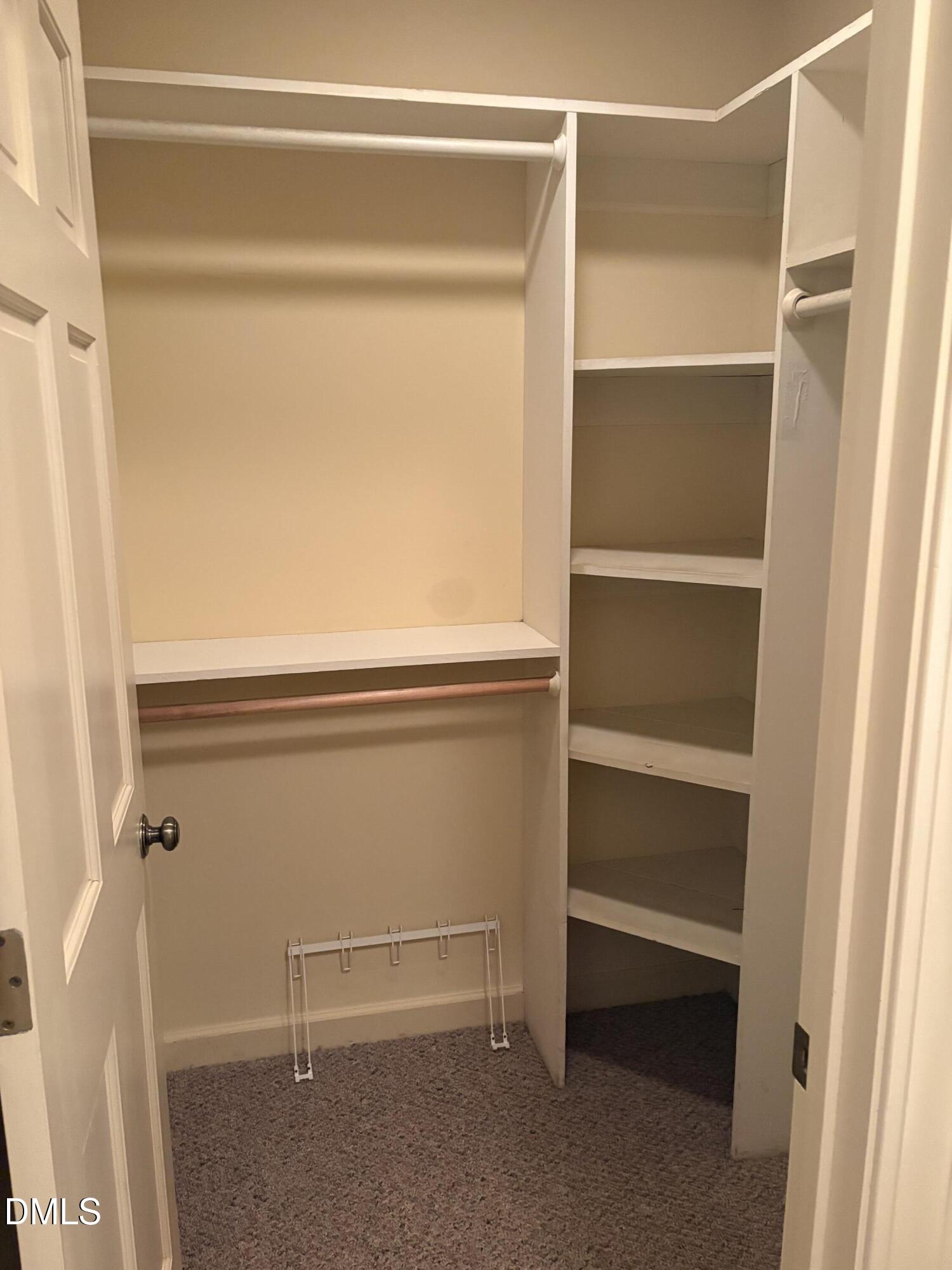 7213 Ridgefield Court Sanford, NC 27332 - Photo 10 of 17 a view of walk in closet with empty racks