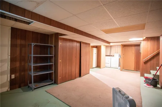 a large bed sitting in a room next to a window