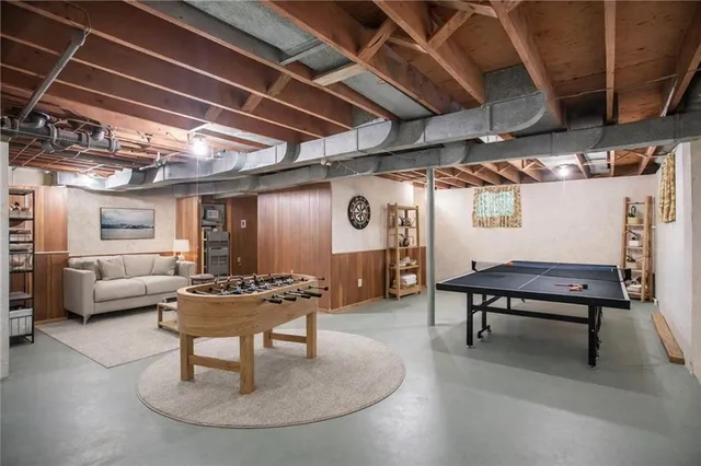 a living room with furniture a piano and a table
