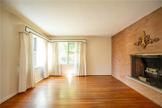 a view of a room with wooden floor and fireplace