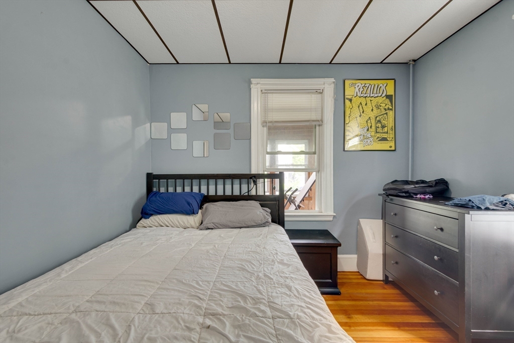 45 Jackson Road Somerville, MA 02145 - Photo 19 of 27 a bedroom with a bed and a window