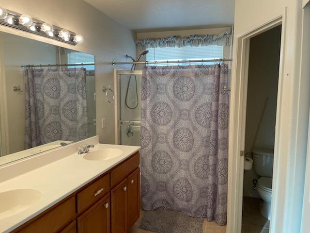 1484 Gemini Avenue Thermal, CA 92274 - Photo 16 of 26 a bathroom with a double vanity sink and mirror