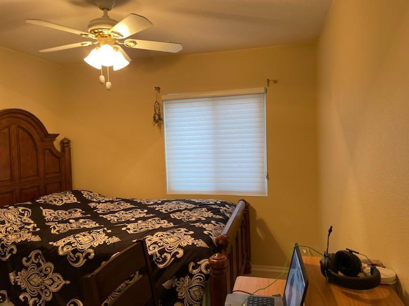 1484 Gemini Avenue Thermal, CA 92274 - Photo 17 of 26 a bedroom with a bed and a chandelier