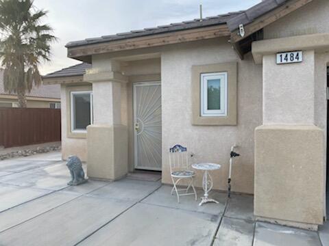 1484 Gemini Avenue Thermal, CA 92274 - Photo 2 of 26 a view of a patio with table and chairs and potted plants