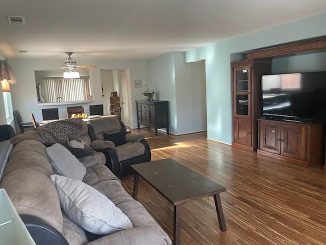 1484 Gemini Avenue Thermal, CA 92274 - Photo 9 of 26 a living room with furniture flat screen tv and wooden floor