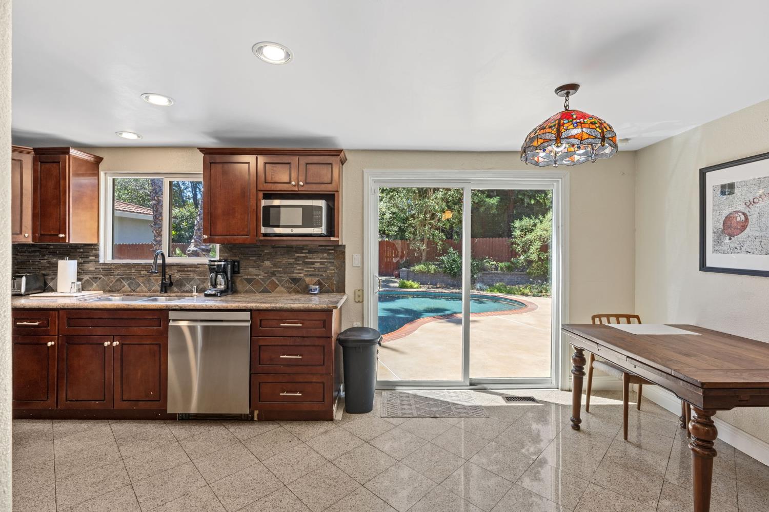 4206 Zephyr Way Sacramento, CA 95821 - Photo 13 of 45 a hall with kitchen island granite countertop a stove and a sink