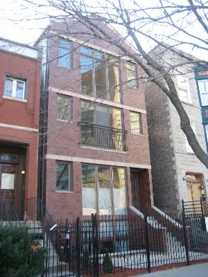 a front view of a house with a tree