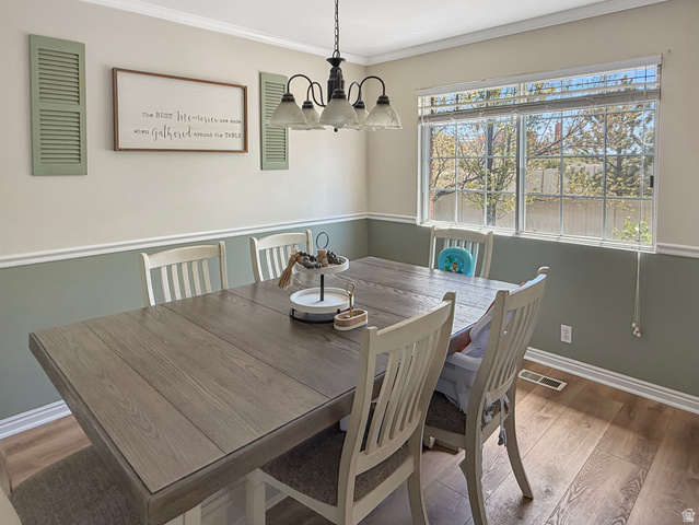 1716 Sagewood Road Price, UT 84501 - Photo 7 of 73 Dining area featuring wood finished floors, crown molding, and suspended lighting