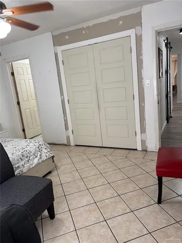 a living room with a couch and a potted plant