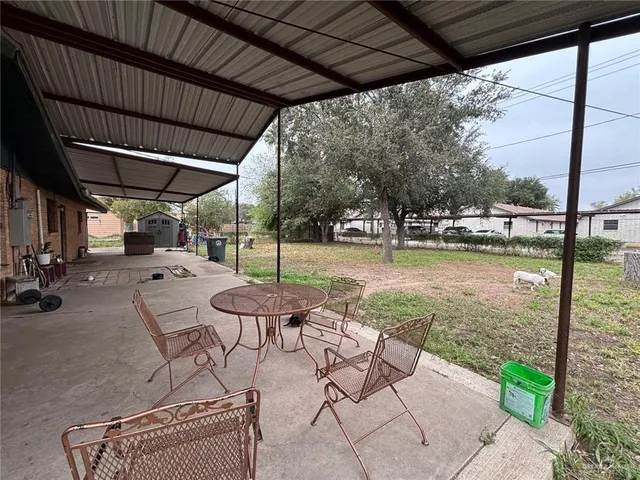 a view of back yard with outdoor seating