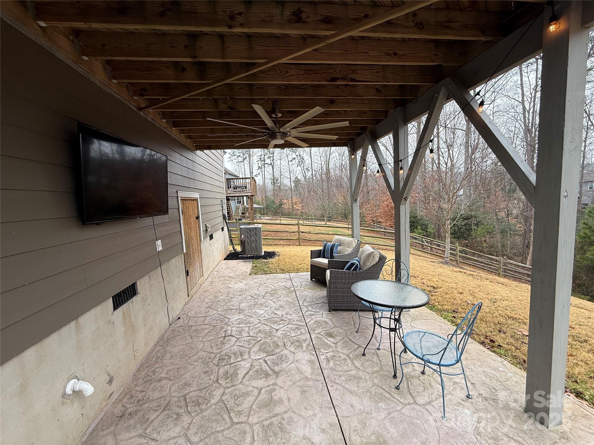 1073 Moonlight Mist Road Belmont, NC 28012 - Photo 19 of 20 a living room with furniture a flat screen tv and a floor to ceiling window