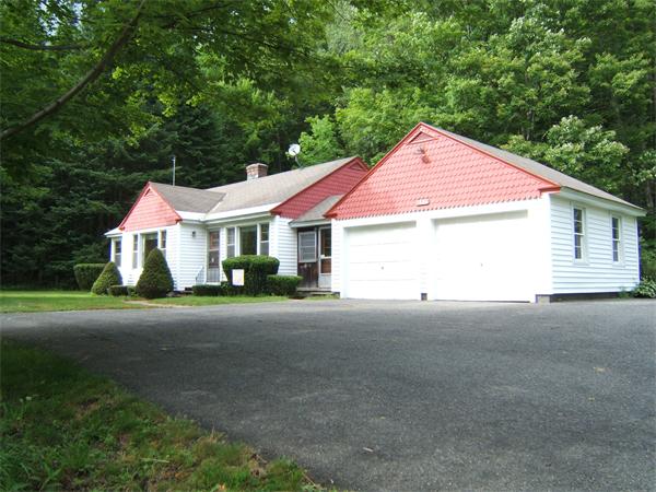 1446 Ashfield Road Conway, MA 01341 - Photo 2 of 23 a front view of a house with a yard and garage