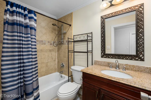 a bathroom with a granite countertop sink toilet mirror and shower