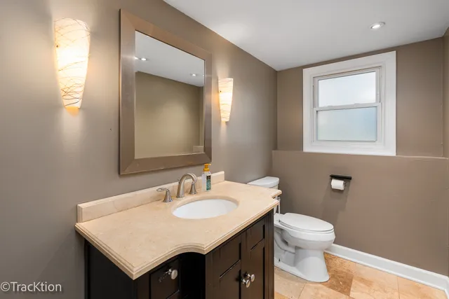 a bathroom with a sink a toilet and mirror