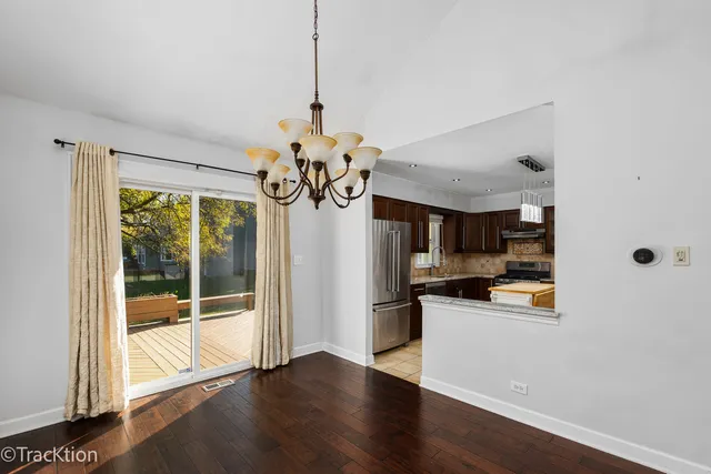 a view of a kitchen with a sink wooden floor and a chandelier