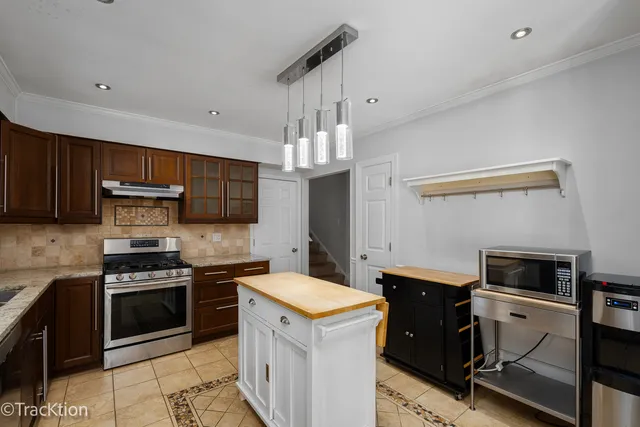 a kitchen with a sink stainless steel appliances and cabinets