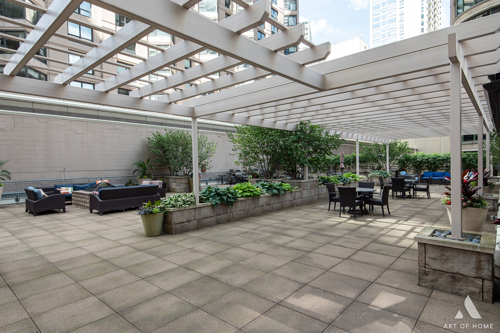 400 East Ohio Street, Unit 2902 Chicago, IL 60611 - Photo 25 of 34 a view of a patio with table and chairs barbeque potted plants and large tree