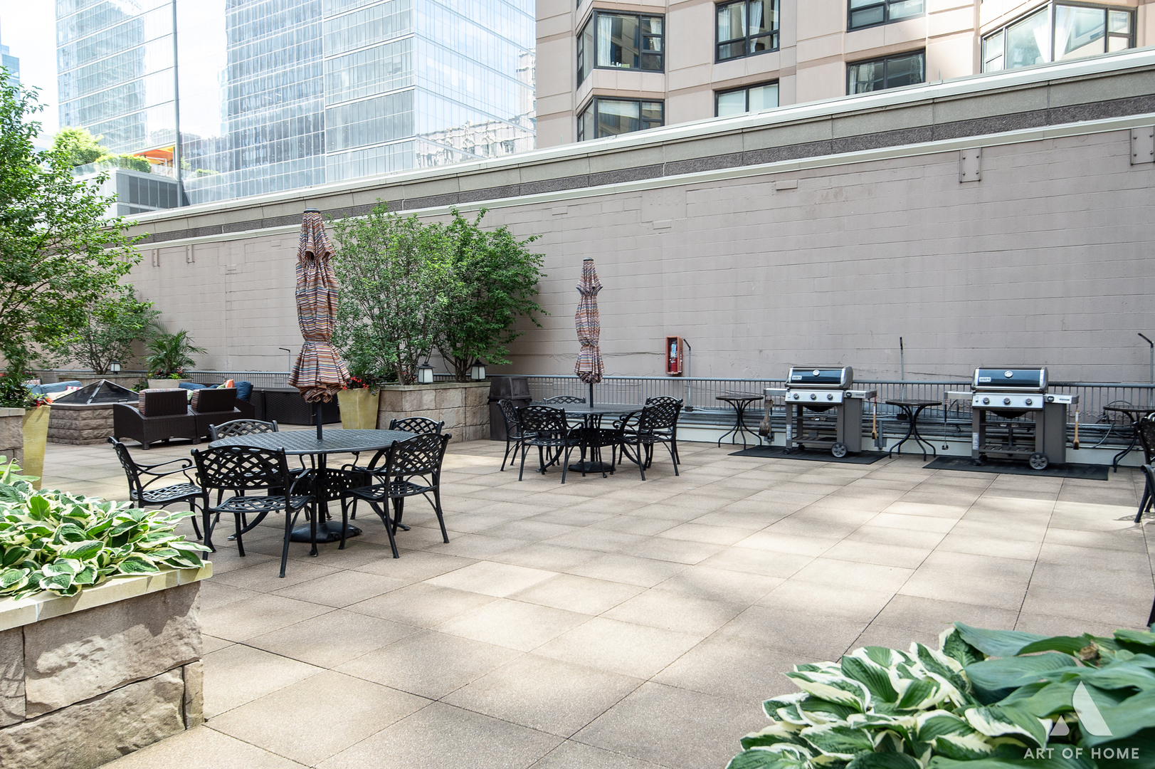 400 East Ohio Street, Unit 2902 Chicago, IL 60611 - Photo 29 of 34 a view of a patio with table and chairs potted plants with wooden fence