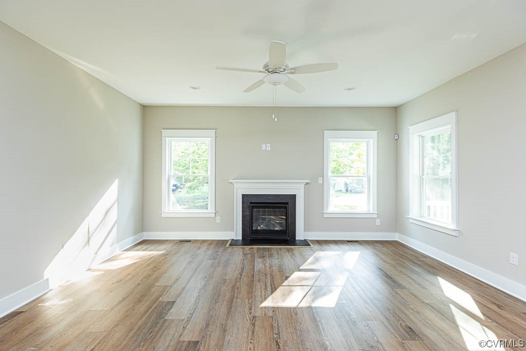 8473 Lincoln Road Mechanicsville, VA 23116 - Photo 14 of 46 an empty room with windows fireplace and wooden floor