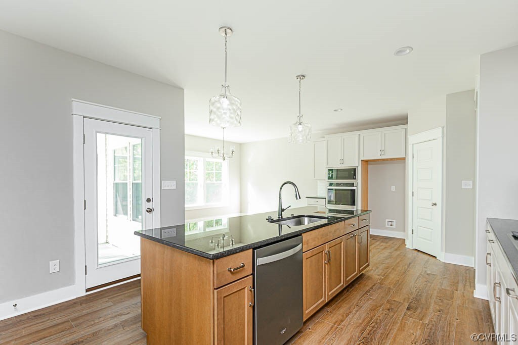 8473 Lincoln Road Mechanicsville, VA 23116 - Photo 4 of 46 a kitchen with stainless steel appliances granite countertop a sink a counter space and wooden floor