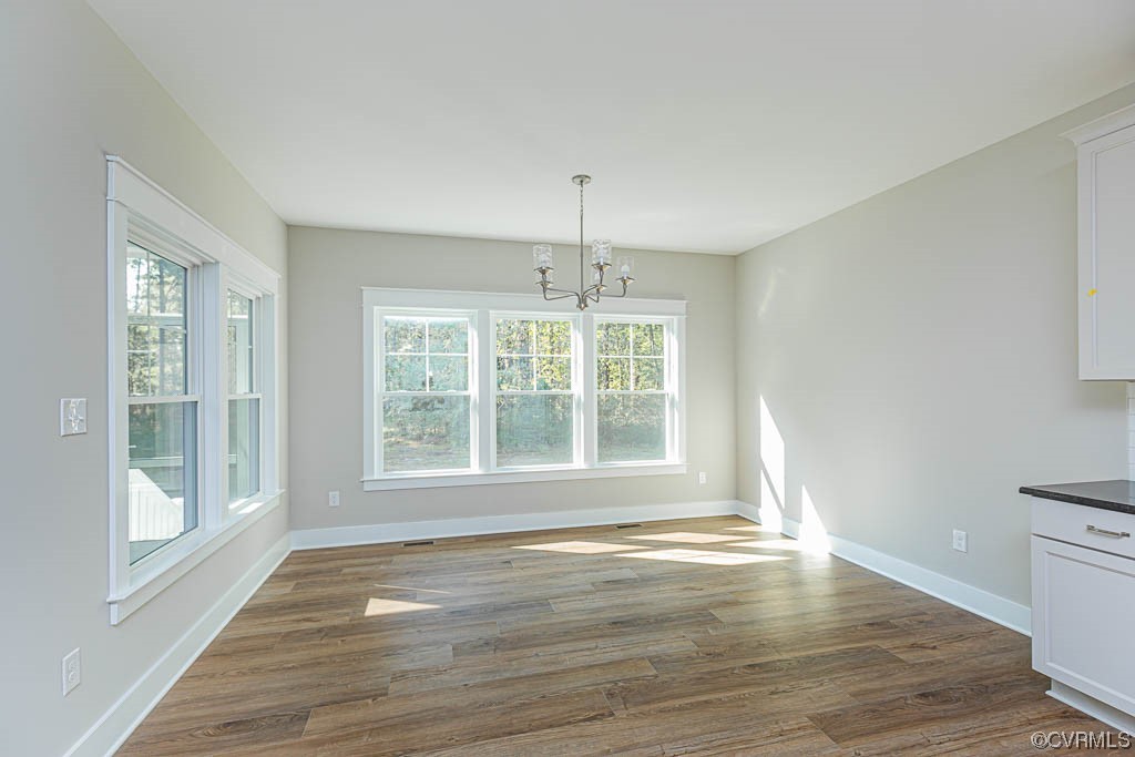 8473 Lincoln Road Mechanicsville, VA 23116 - Photo 9 of 46 a view of an empty room with wooden floor and a window