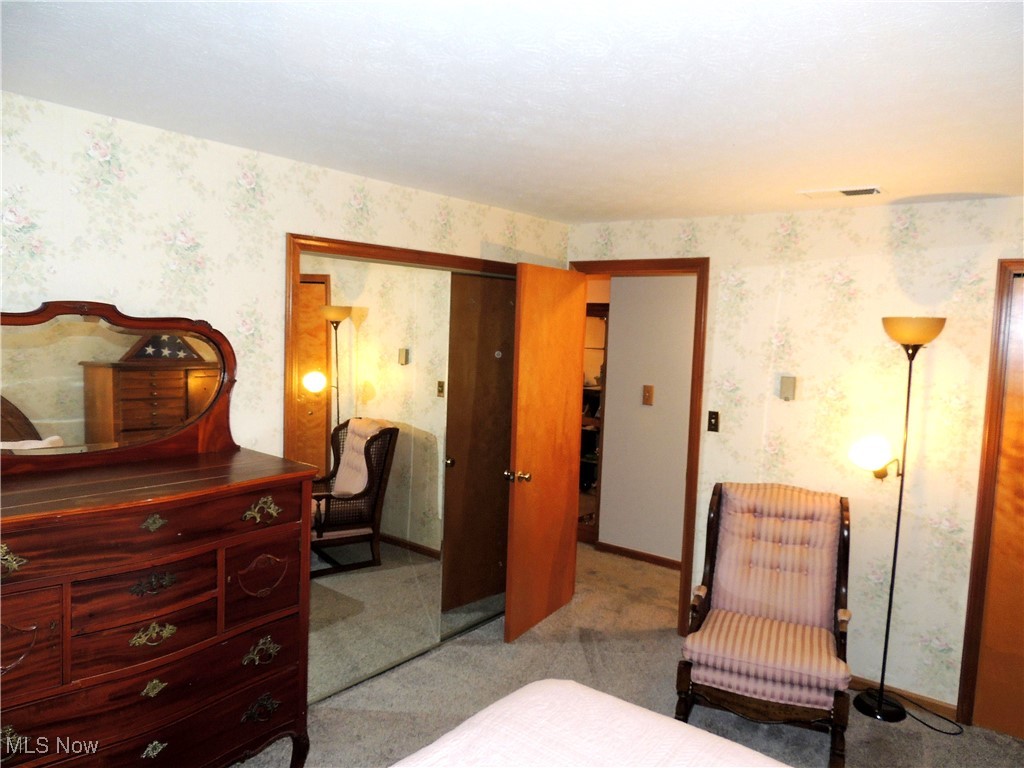 3070 Kent Road, Unit 406 Stow, OH 44224 - Photo 17 of 33 Bedroom with light colored carpet, wallpapered walls, and a closet