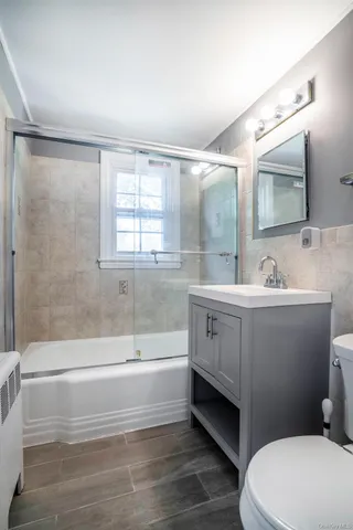 a bathroom with a sink a toilet and bathtub