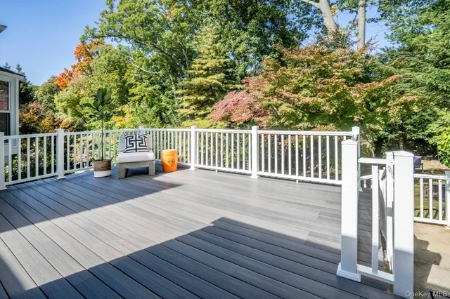 a view of balcony with wooden floor and fence