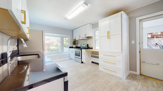 a kitchen with granite countertop a refrigerator and a sink