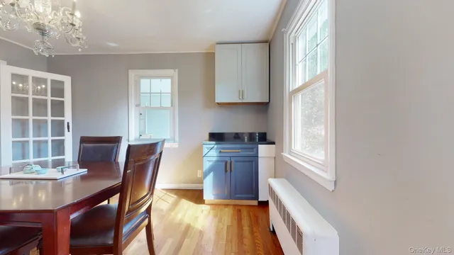 a kitchen with a table chairs and wooden floor