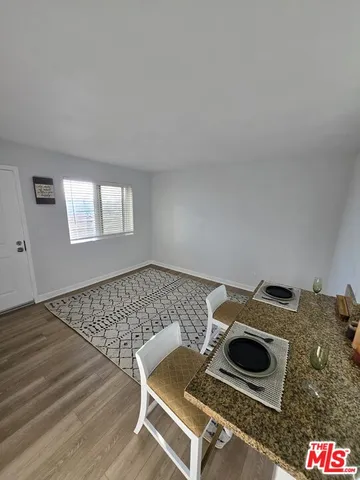 a living room with a rug and a stove