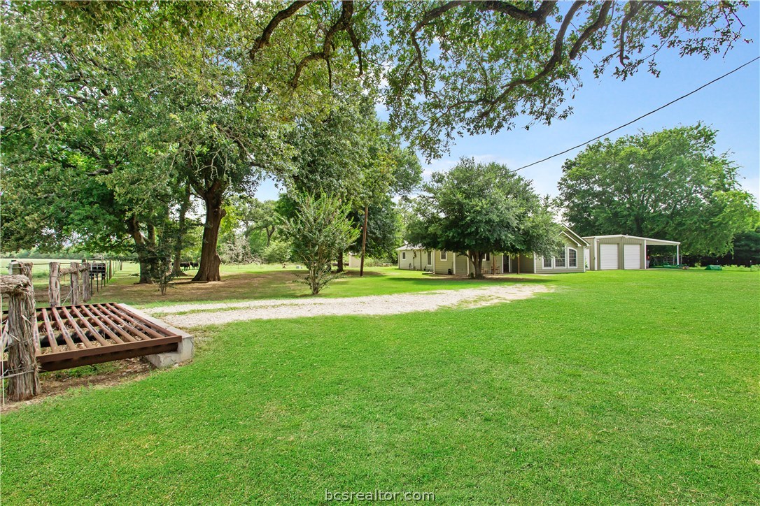 a view of green field with sitting area