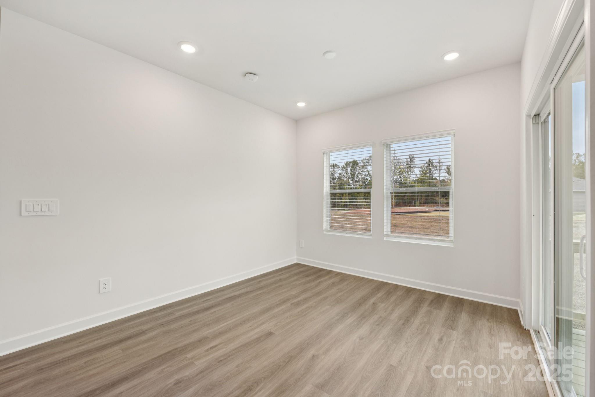 712 Palmer Pendleton Way York, SC 29745 - Photo 6 of 36 an empty room with wooden floor and windows